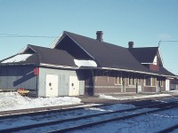 Here is an image of the old CN station at Merritton, taken on a mid-winter's afternoon.  It was used at this time as a section house and local crews office area (track car shed on close end) as it was at the junction of the CN Grimsby Sub and the Thorold Sub. A small yard where St. Catharines locals worked out of can be seen in behind. Two engines were based there.
The station met its' untimely demise on October 23, 1994 when the structure succumbed to flames. Arson was the cause and I am not sure if the culprits were ever apprehended.