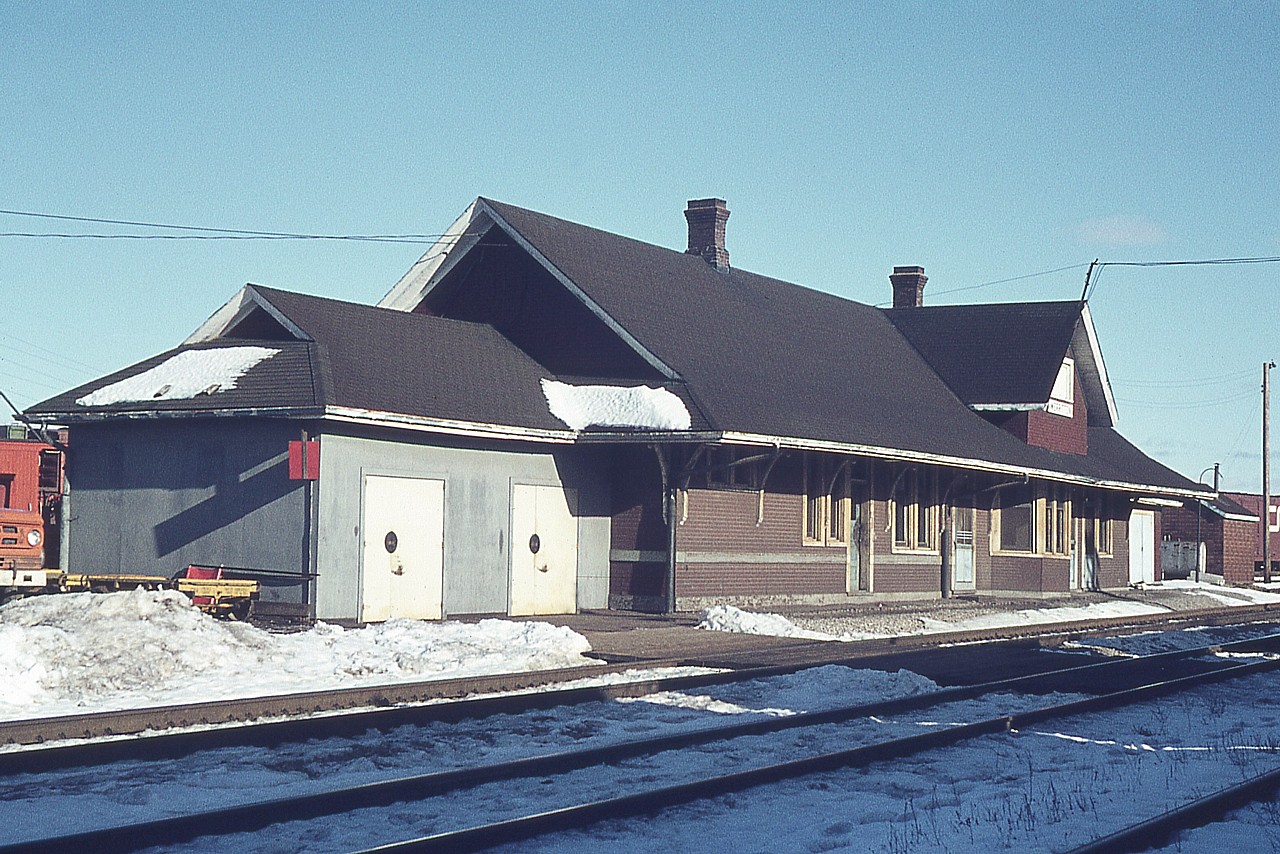 Here is an image of the old CN station at Merritton, taken on a mid-winter's afternoon.  It was used at this time as a section house and local crews office area (track car shed on close end) as it was at the junction of the CN Grimsby Sub and the Thorold Sub. A small yard where St. Catharines locals worked out of can be seen in behind. Two engines were based there.
The station met its' untimely demise on October 23, 1994 when the structure succumbed to flames. Arson was the cause and I am not sure if the culprits were ever apprehended.
