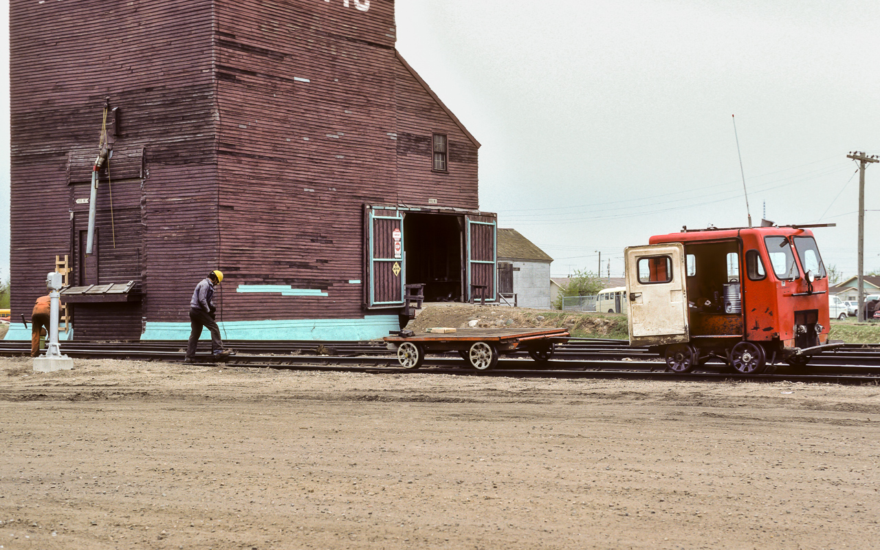 This is a scene that I have not seen trackside in several years. One fellow pounding in spikes that have lifted, the other tightening the bolts on rail joints. Plus a little flat car in tow with a rail jack as a load. Same speeder as the one that I just posted a while back and I still cannot make out the number (for those who may inquire).