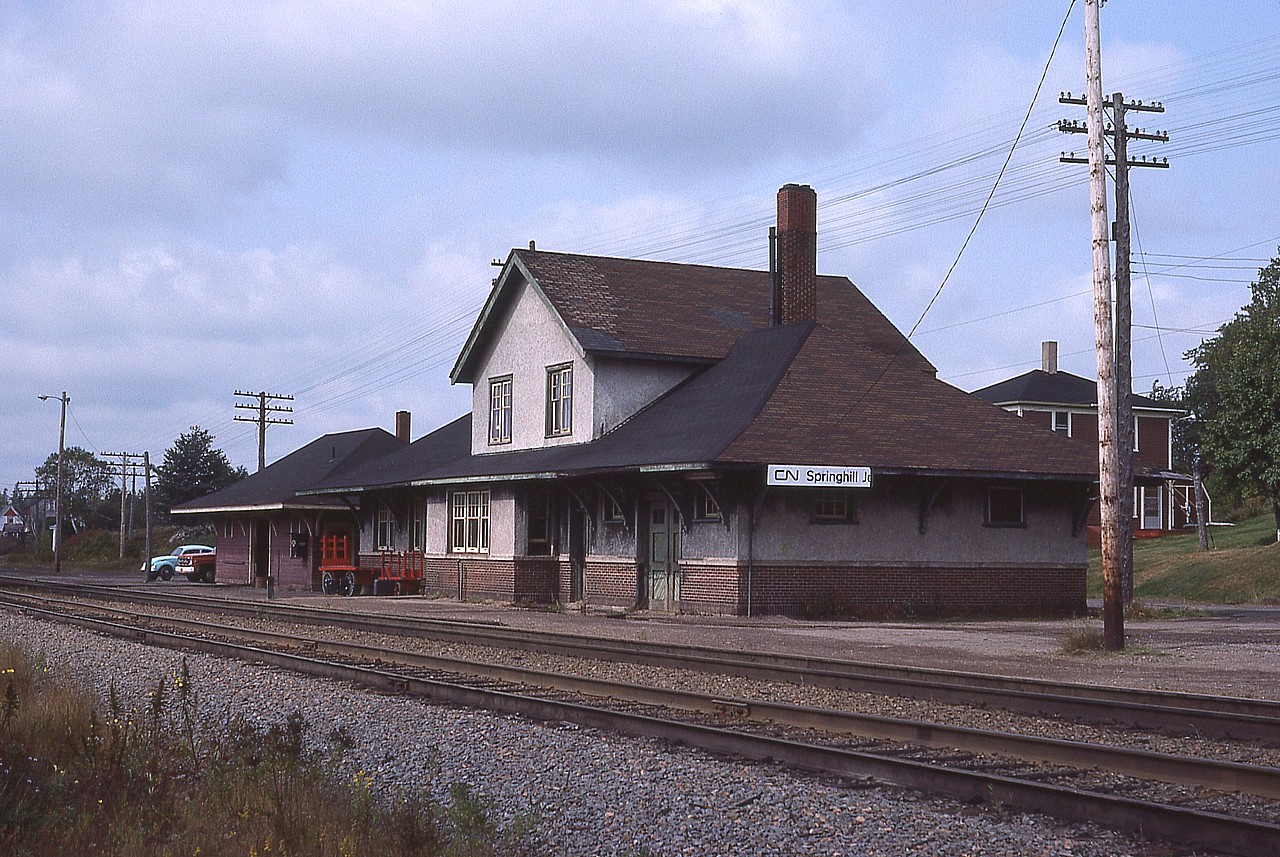 In 1872 the Intercolonial Railway went thru. In 1877, a short Springhill and Parrsboro Rwy was established. The junction became Springhill Jct.
After 1884 the Sp&P became known as the Cumberland Railway & Coal Company, and it retained that name for the rest of it's existence. 
The Intercolonial became known as the Canadian Government Railway after 1915, and then merged fully with the Canadian National Railway in 1918.
The Cumberland line was abandoned in 1962 after business dried up. The deadly explosion in #2 Coal Mine in Springhill on the 23rd of October, 1958 was the final nail in the coffin, so to speak, after 75 men lost their lives in one of the worst mining disasters in Canadian history..
The station at Springhill Junction is long gone, but the VIA schedule still lists a station there, as a flag stop for those wanting to ride the "Ocean".
I did not recall a station there when I visited in 2017, so looked it up. The "station" is a sign post. Geez.