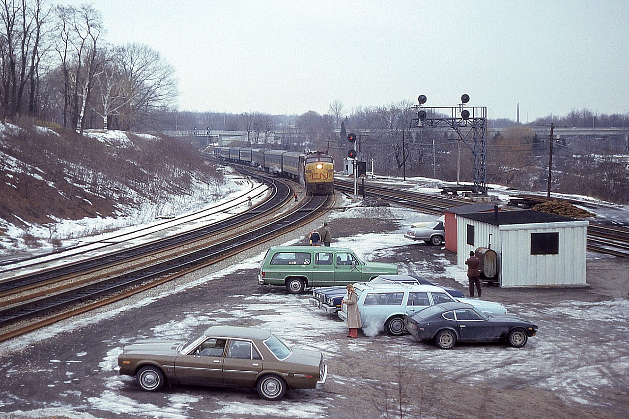 A little something different is a "people picture" showing a gathering of fans at the Junction, where there was always someone most days; good weather or bad. I have no info written with this pic; I guess back then it was just a shot I felt was meaningless, but after all these years it has taken on a different status. I am almost sure this is a weekend crowd, but have my suspicions when I see Bill McArthur over by the oil tank getting his photo, and the exhaust shows his blue station wagon is indeed running. He did work the odd Saturdays so this could have been one of them.......and just stopped in to see what was happening. But I worked most Saturdays....maybe I was on holidays..the weather seems to indicate it... and, it all makes me think this shot could be of #73. Anyway, those days are long gone. It was fun while they lasted.