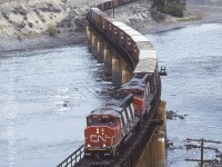 CN 9552 and 9610 are crossing the Thompson River at MP 45.8 on CNs Ashcroft Sub. They will shortly skirt the Village of Ashcroft as they make their way further west. CPs Thompson Sub runs parallel here but goes through the rail yard and village rather than around it. Not much has changed here since '95. Still a wonderful place to spend the day and shoot trains.