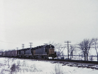 A trio of GP35's, C&O 3523,3528 & 3537 on a eastbound freight have just clattered over the diamond at Canfield Junction on the now long gone CASO sub. The C&O had running rights on this track from St.Thomas. I was about half way between the diamond and Junction Road which crosses the double track mainline. If I recall Junction Road crossing was protected with the old style "wig wag" light and of course it never occurred to me to take a picture of the wig wag arm and light. On this day, Bruce Mercer and I spent time at Canfield as well as E&O Tower further east of Canfield. 9 trains were seen this day, from 4 different railways, including TH&B at E&O.
