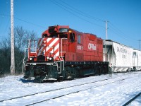 In the mid 1990’s the Guelph Junction Railway (GJR) lived a fairly quiet existence serving the city of Guelph with a Canadian Pacific local that was based out of Guelph Jct. in Campbellville.  While the Guelph to Guelph Jct. portion was owned by the city, the GJR line was operated by CP and once extended to Goderich on Lake Huron. Officially named the Goderich Subdivision, the section between Guelph and Goderich was abandoned in 1988 after the last run occurred on December 16, 1988 with GP38-2 3032. The rails between Goderich and the Guelph city limits were lifted in 1989.  
<br>
By 1994, the remaining Guelph industries that utilized rail service by GJR included; ABB, Guelph Utility Pole, W.C. Wood Company, the Guelph Co-Op, Huntsman Corporation and Owens Corning, with the latter two getting the most cars. The other customers received rail shipments infrequently and runs to the interchange with CN occurred only as needed during the week. 
<br>
The typical weekday for the CP Guelph local’s crew was to switch the small yard and the nearby lumber companies at Guelph Jct. during the morning. This occurred after all the weekly morning GO Transit sets departed eastbound for Toronto. After its work at Guelph Jct. was completed the job would depart westbound on the Galt Subdivision to Puslinch to service the transload that was situated beside the siding and mainline. Following its work here, the local would return to Guelph Jct. where the crew completed any additional switching prior to departing for Guelph if required with usually a small train. 
<br>
After arriving light power from Campbellville, here CP GP7u 1501 is seen lifting a hopper car of clay in the yard at Stevenson Street in Guelph. Soon the job would depart for the Owens Corning glass plant located along York Road on a very cold but sunny winter day. 

