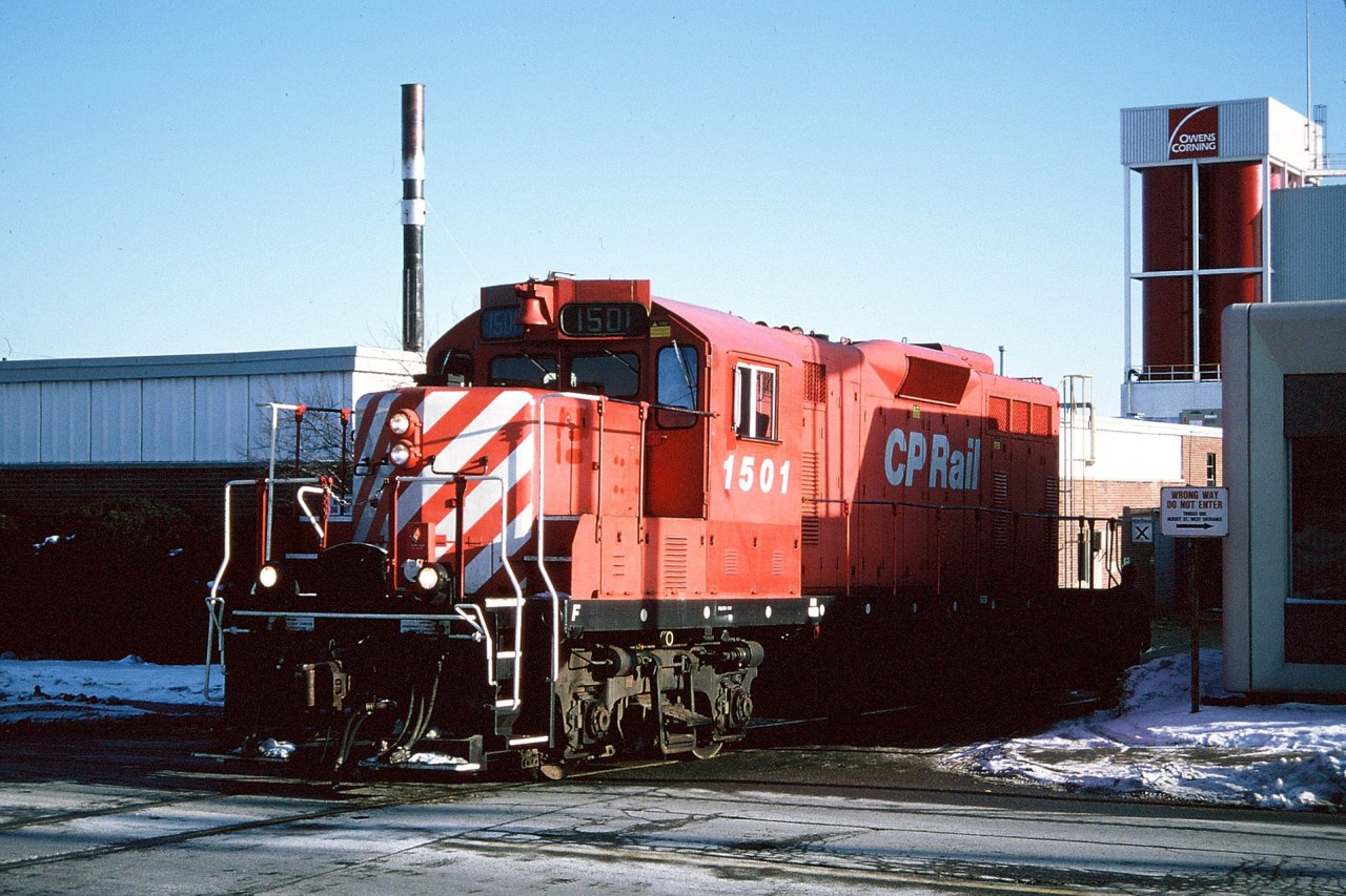 CP GP7u 1501 is viewed switching the Owens Corning facility located along York Road in Guelph. This was a regular switch for the CP Guelph local job during the mid-1990s. In the winter months when the sun was lower the shadows here could make it tough to photograph depending on when the local arrived at the plant. The crew could sometimes spend quite a bit of time here lifting and setting-off hoppers that had clay in them for the manufacturing of fiberglass composites. This day, 1501 set-off and lifted one car before proceeding to switch the Huntsman Chemical Corporation plant on its way back to Guelph Jct.