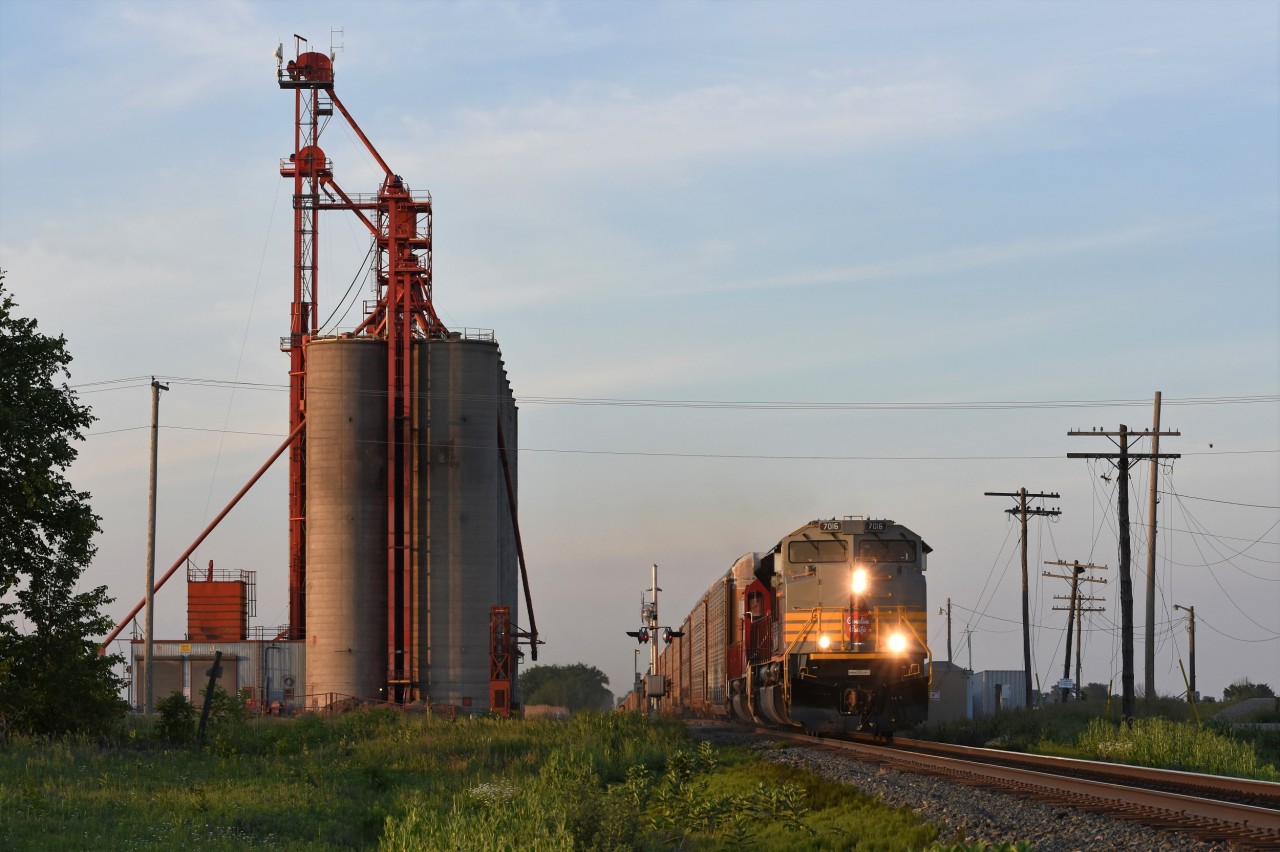 CP 147 with a heritage paint ACu in the lead and ex. SOO 6027 in second, roars past the massive grain elevator at Glencoe. About a week prior to this shot the facility was even larger as the remains of 4 smaller concrete bins as well as demolition equipment could be seen in the spot where they once stood.