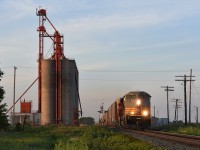 CP 147 with a heritage paint ACu in the lead and ex. SOO 6027 in second, roars past the massive grain elevator at Glencoe. About a week prior to this shot the facility was even larger as the remains of 4 smaller concrete bins as well as demolition equipment could be seen in the spot where they once stood. 