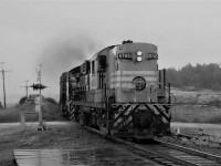 The rain has finally stopped as CP RS-18 8745 and SW1200RS 8171 lead a short train over Lake Huron Drive in the small town of Desbarats as they continue their journey to Sault Ste Marie.  The mileage indicated is approximate.