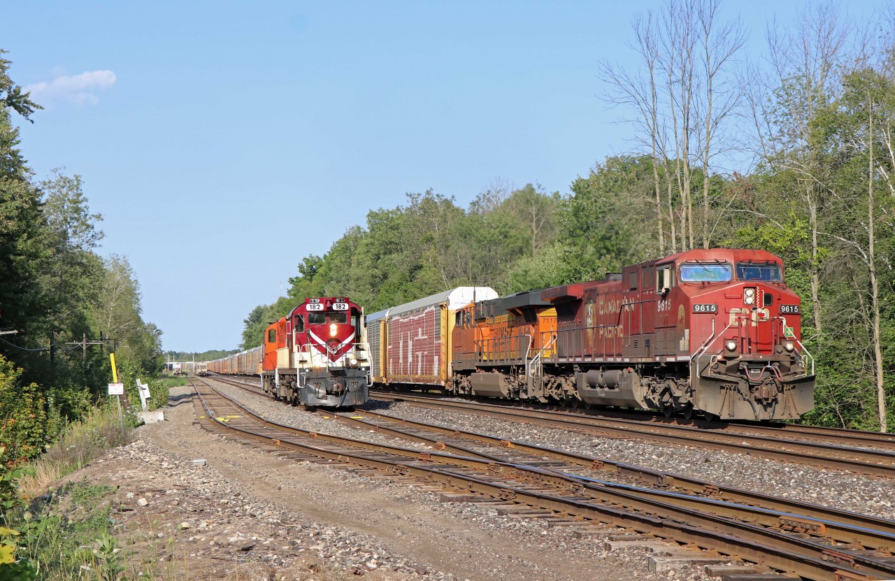 CP train 147 overtakes an Ontario Southland Railway assignment switching at the west end of Guelph Jct. Power on 147 is CP AC4400CW 9615 and BSNF ES44C4 7117 while the OSR has RS18u 182 and GP9u 1591 (former QGRY/CP 1801, built as 8764; and 1591, built as 8487). Special thanks to the OSR hogger for making this shot possible--he made sure that 147 passed him prior to the crossing, making for some great video as well as an interesting photo!