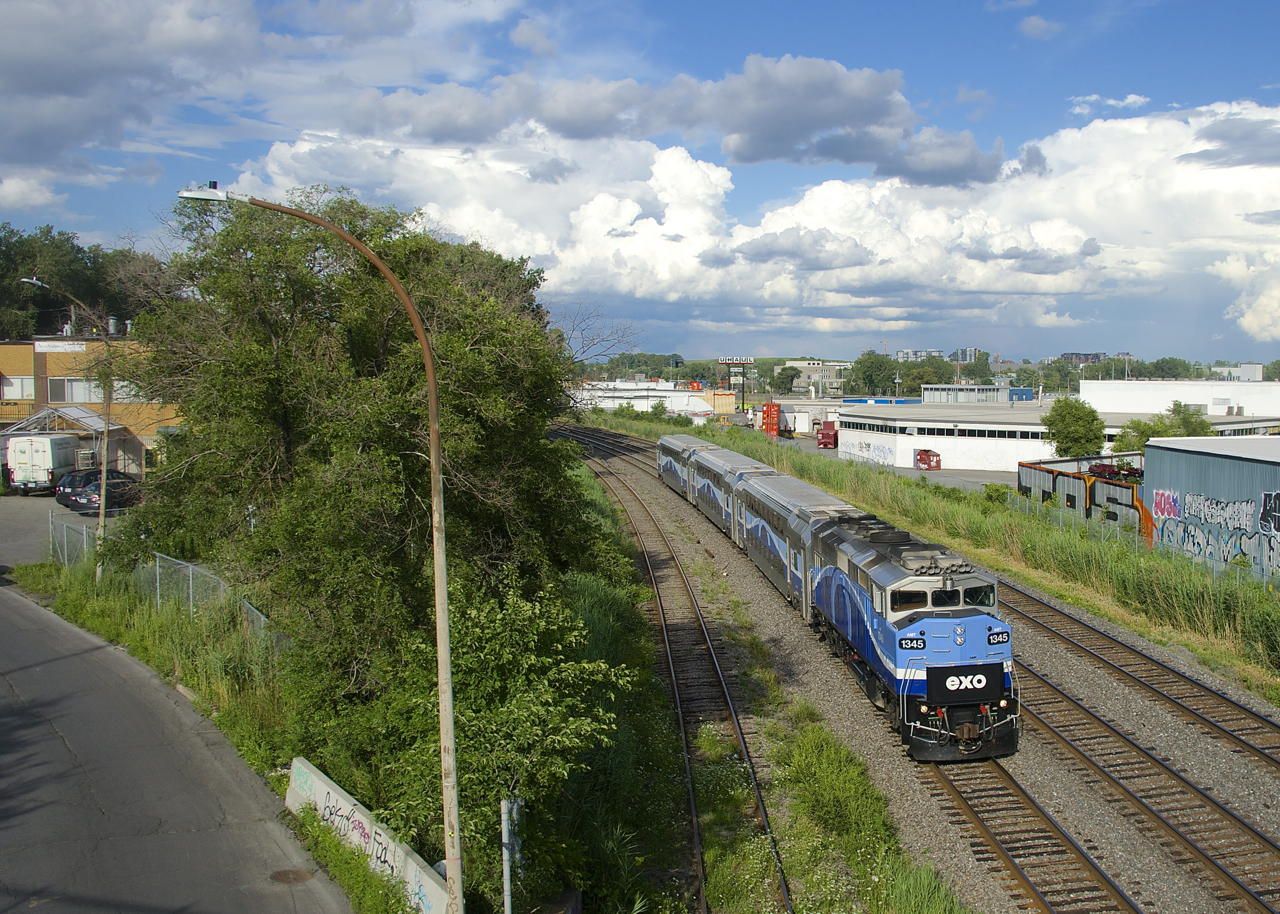 With quite a large number of clouds in the background, EXO 1211 heads west with AMT 1345 leading. A large thunderstorm would develop about an hour and a half later.