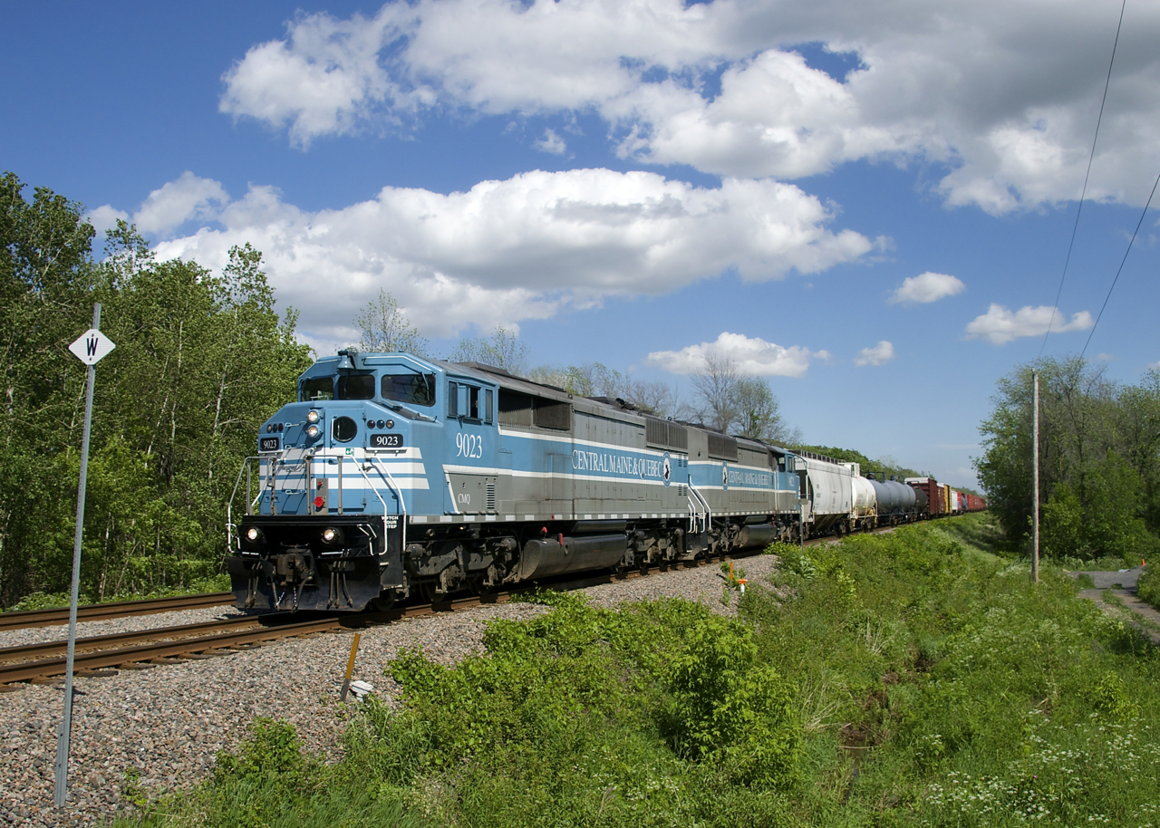 After having to take it slow due to CP's bridge over the St. Lawrence Seaway being raised, CP 253 with CMQ 9023 and CMQ 9022 for power is pouring it on, with the signal at Adirondack Jct showing a clear aspect.