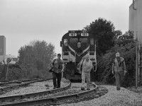 <b>Final Frame.</b>  Conductor Paul Jarvis, Engineer Andrew Nichol, and Conductor Karol Belawski (left to right) have tied down the final OSR movement over the Guelph Junction Railway, closing out 22 years of operations.  All the best to the boys of the OSR.