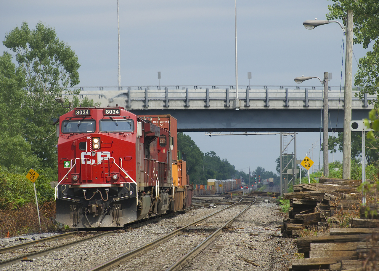 CP 143 temporarily advances towards Dorval Station during a brief period of sunshine as it puts its train together. Soon it will back up and get ready to depart westwards. In the far distance counterpart CP 142 is lined on the south track at Lachine Station and the tail end of CN 106 heads east.
