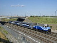 The three cars and F59PH making up EXO 1211 have next to no EXO markings as they head west on CN's Montreal Sub.