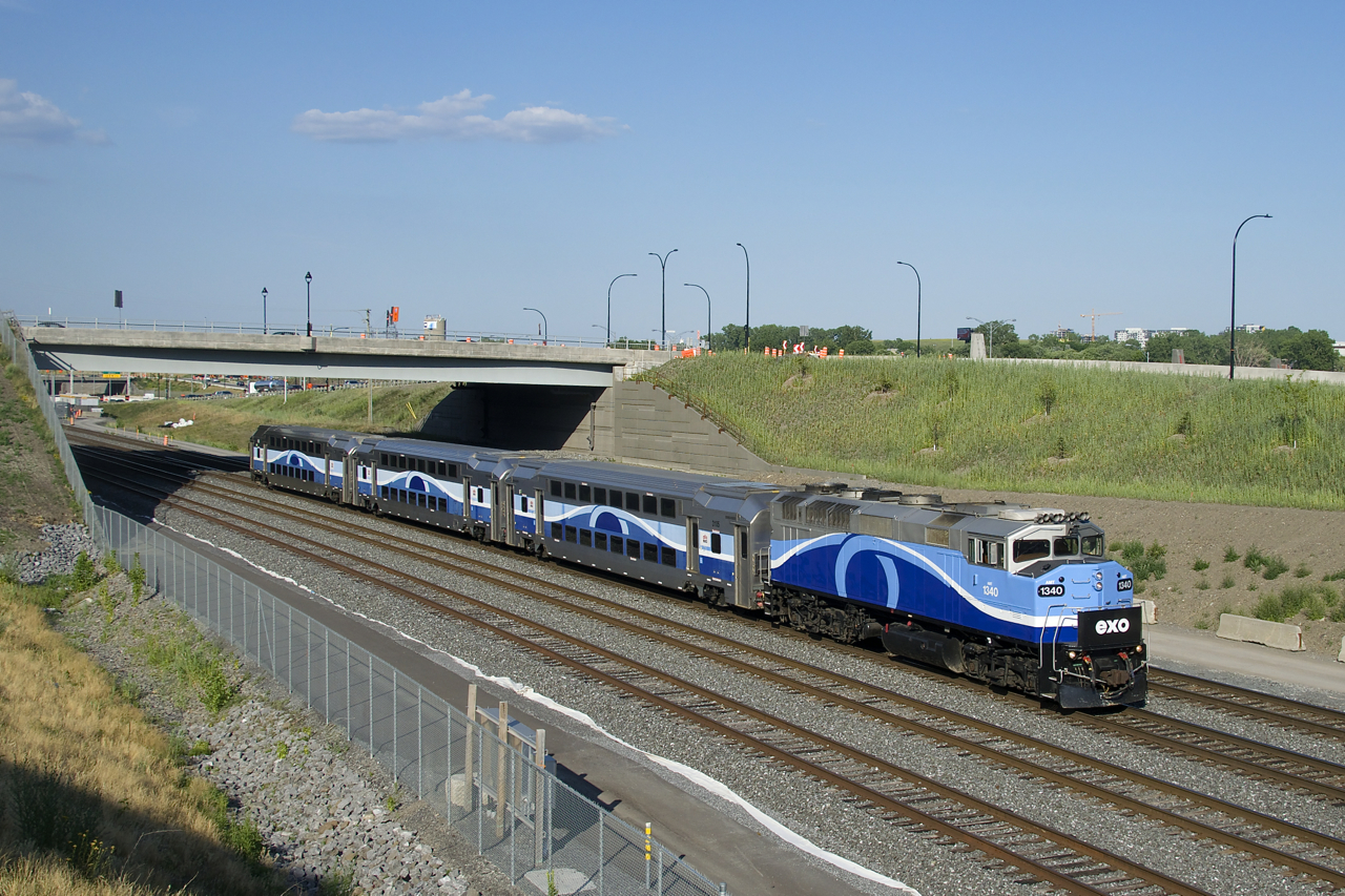 The three cars and F59PH making up EXO 1211 have next to no EXO markings as they head west on CN's Montreal Sub.