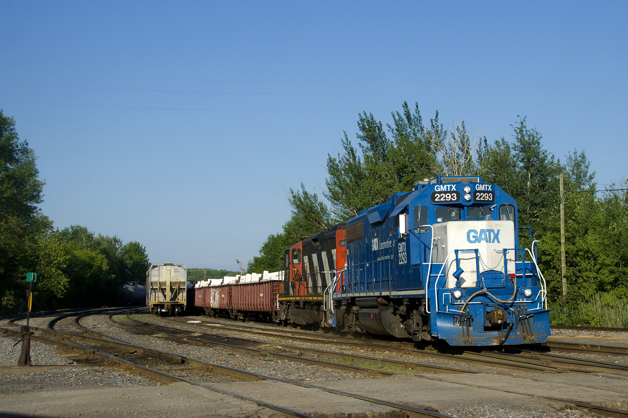 CN 536 with GMTX 2293 & CN 4141 does some switching behind the Coteau Station on a sunny and humid evening. At the head end are covered gons with zinc for a client in Valleyfield.