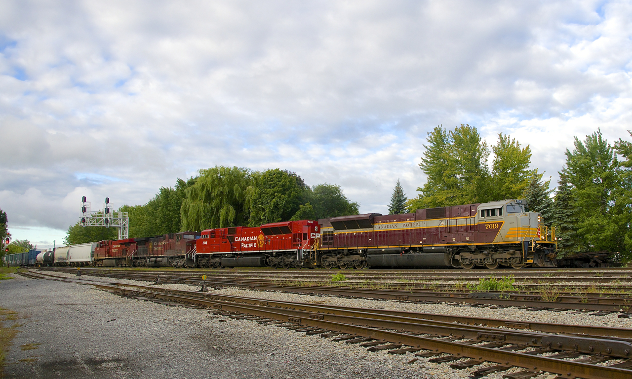 CP 253 is passing Lasalle Yard with two sets of CP 252's power, which provide quite a contrast in appearance. Up front are quite new SD70ACU's CP 7019 & CP 7045, behind them are two dirty GE's (CP 9718 & CP 8878).