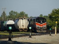 A rail train is parked in Smiths Falls Yard with CMQ 9017 & CMMQ 9011 for power. In an hour it will leave to pick up rail on CP's Winchester Sub, which is being converted from double track ABS to single track CTC.