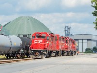 The crew of TH11 is in Hamilton's Eastport area, and are running around their train so that they can take some loads of plate steel to Great Lakes Stevedoring. The domes in the background are Agrico's.