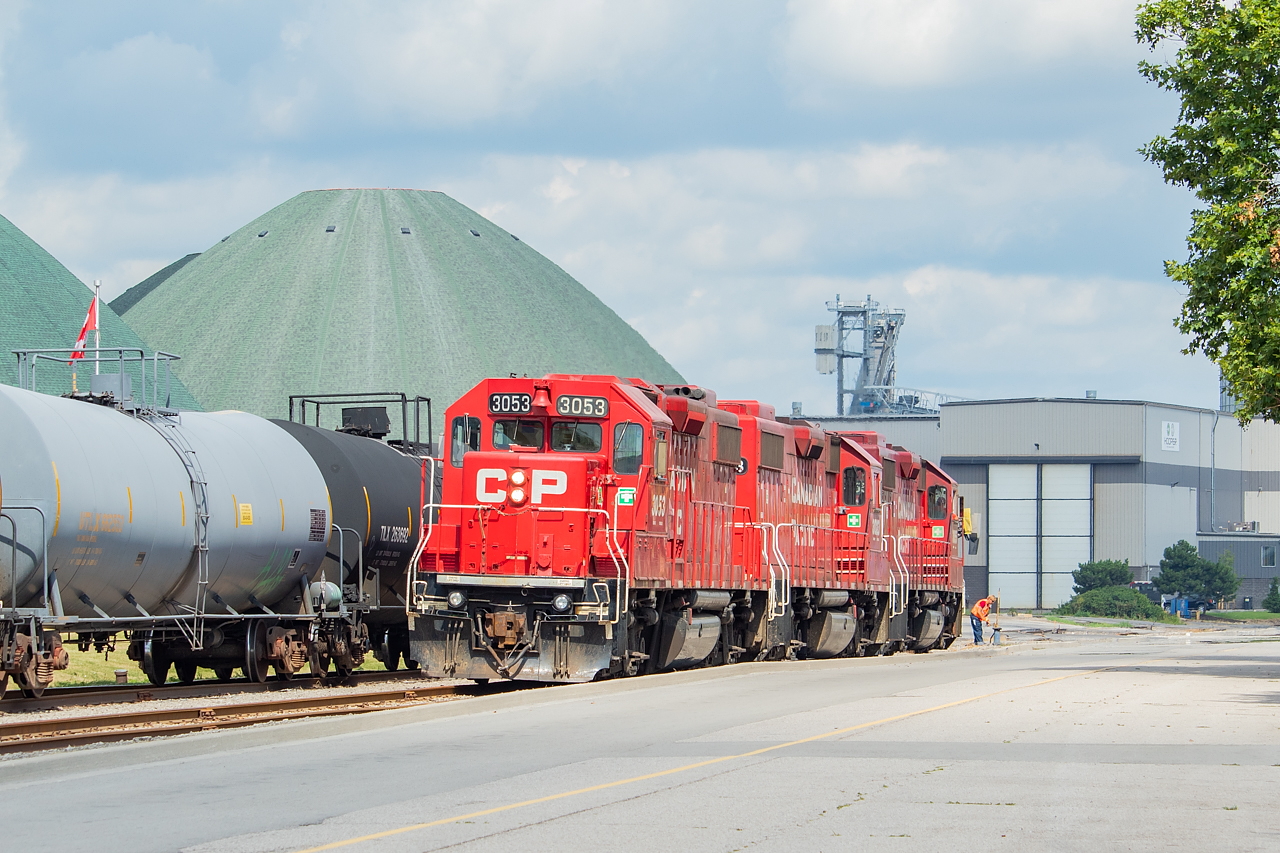The crew of TH11 is in Hamilton's Eastport area, and are running around their train so that they can take some loads of plate steel to Great Lakes Stevedoring. The domes in the background are Agrico's.
