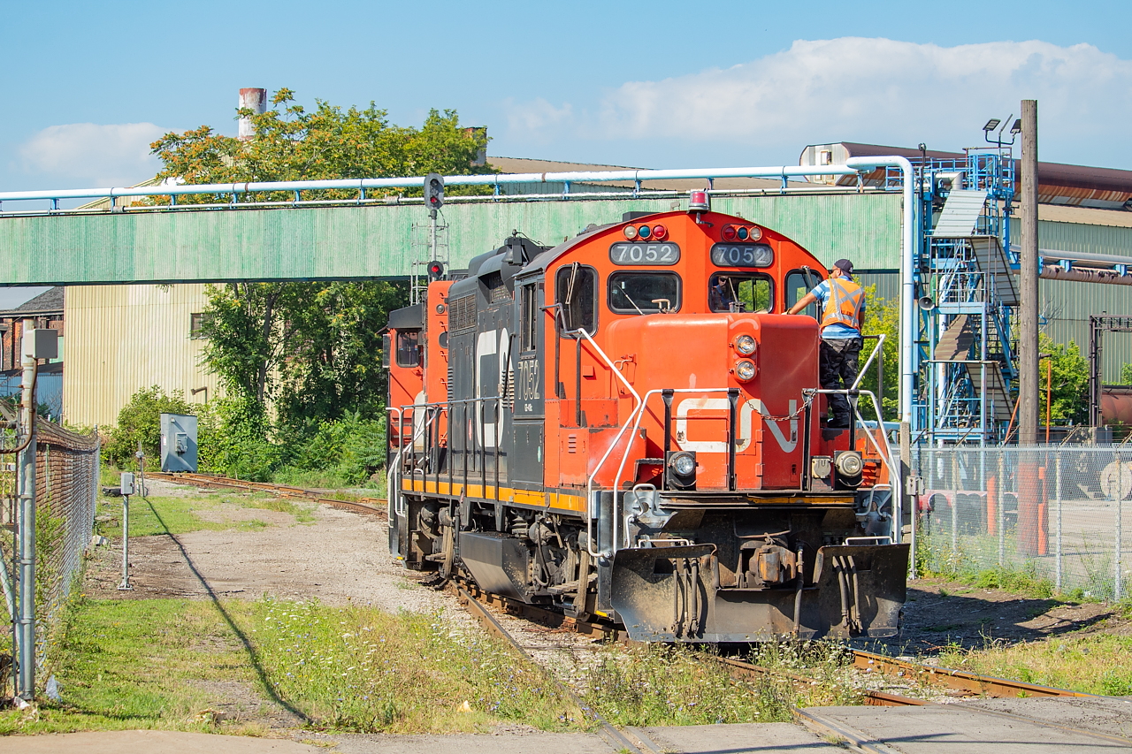 The CN 0700 Yard Job has just dropped some coil cars and a boxcar at Railcare, and is pictured here on the south side of Burlington Street shoving back out towards the N&NW Spur. The signals pictured protect the diamond known as Irondale.