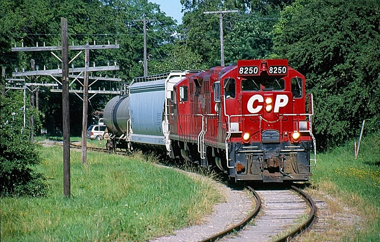 I have always had an interest in the Owen Sound subdivision. I so wish I could have railfanned it in its heyday or at least photograph a train north of Orangeville. Unfortunately I have to settle for the shots I have of it being dismantled. My father has many childhood memories of the line especially trips to Orangeville and Harrison to visit family. When I heard CP was pushing to rid itself of the line I knew I had to do my part and at least capture a few images of what remained before it too was gone. In the last year's I spent some time in Streetsville and Brampton trying to chase the train north to Orangeville when time allowed. A few time I was lucky enough to follow them and watch the switch in Orangeville before heading south often in the evening. This day I caught up with the short train and it's two GP9U'S just after finishing in the yard. From here the train went to work the few remaining customers in an industrial park on the northwest side of town. The line side poles certainly give the line a true branchline feel.