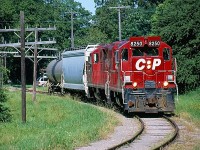 I have always had an interest in the Owen Sound subdivision. I so wish I could have railfanned it in its heyday or at least photograph a train north of Orangeville. Unfortunately I have to settle for the shots I have of it being dismantled. My father has many childhood memories of the line especially trips to Orangeville and Harrison to visit family. When I heard CP was pushing to rid itself of the line I knew I had to do my part and at least capture a few images of what remained before it too was gone. In the last year's I spent some time in Streetsville and Brampton trying to chase the train north to Orangeville when time allowed. A few time I was lucky enough to follow them and watch the switch in Orangeville before heading south often in the evening. This day I caught up with the short train and it's two GP9U'S just after finishing in the yard. From here the train went to work the few remaining customers in an industrial park on the northwest side of town. The line side poles certainly give the line a true branchline feel.