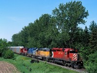 This day myself and fellow Railfan Brian Switzer found ourselves in Cambridge trying to find 234, which was apparently working Galt. After checking the mainline with no luck we stumbled over him at a location once know as Finnigan. The location is right beside the large Babcock & Wilcox ant in Cambridge, a location once served by bother CN and CP as both lines run parallel to eachother there. Today the old CN name sign is long gone and the area rebuilt not to mention CN no longer runs down that far on the Fergus spur. CP also no longer has mainline trains come and work that far up the branch with all lifts and drops basically done at Wolverton. After seeing CP 234's nice consist thus day we made a run for the farmers field near the one-time end of the siding at Killean ( another name that has vanished since the siding was severed at one end. The impressive consist had SD40 6016 leading one of HLCX's former UP SD40's, as well as a CEFX AC4400 and SOO Line wide cab SD60M.