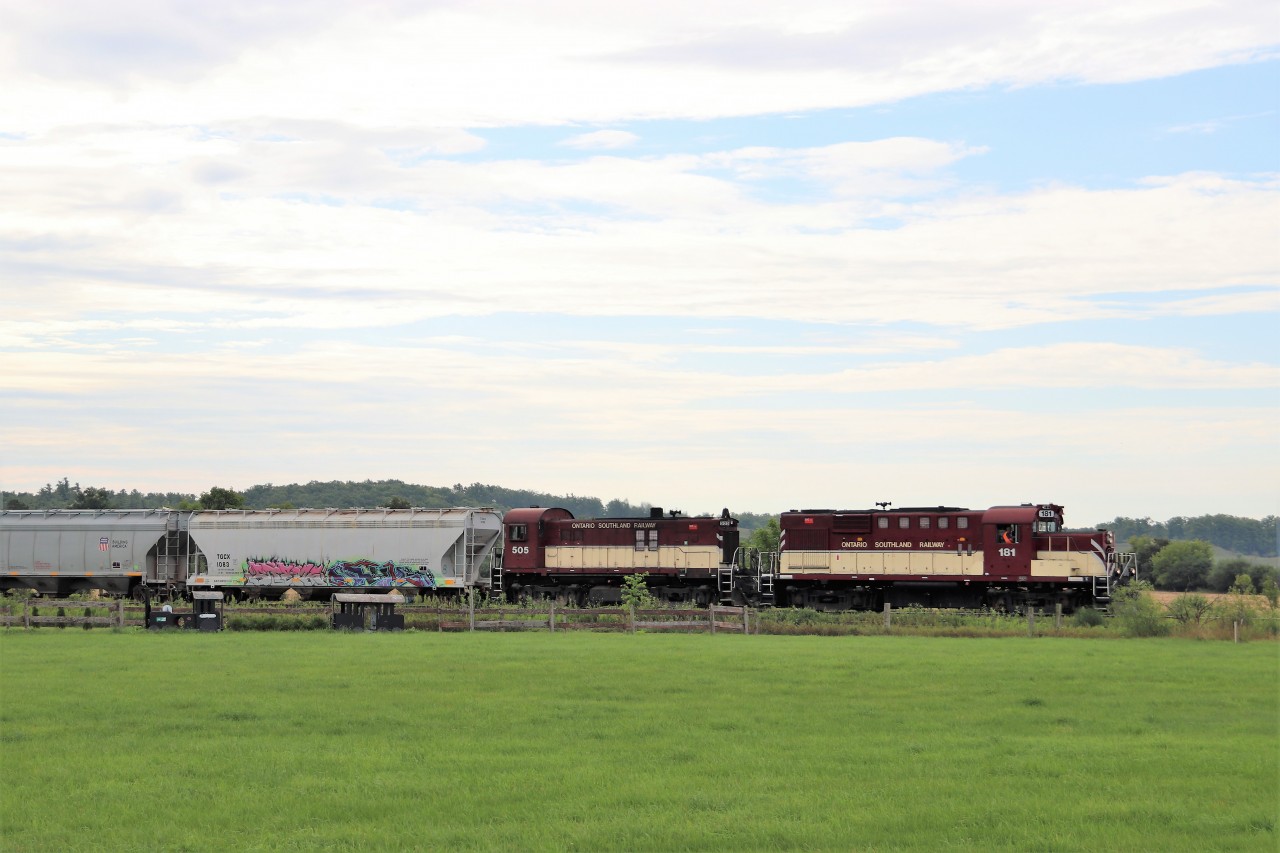 With the Ontario Southland Railway nearing the end of its run, and the cloudy overcast skies, I decided to venture out and shoot it today. The OSR's path runs in the worst conditions for bright sun as almost all shots will be right back in to it, so the overcast skies helped. A pair of MLW's in RS18u, 181 and RS23, 505, make their way through the village of Arkell past a model of a train standing in the horse yard. We may not be able to see a pair of locomotives built in 1958 and 1959 in these parts for much longer, if ever after next week.