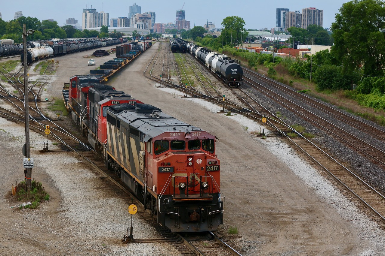 CN 2417 has certainly seen a good number  years of hard work. Faded and scared paint as well as worn and warped roof panels tell the tale. While the cowl Dash-8 days are numbered several are still very active on the roster. London's skyline looms in the background as train 509 puts its train away in the yard. In a few short hours the power set will head train 434 to Toronto.