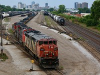 CN 2417 has certainly seen a good number  years of hard work. Faded and scared paint as well as worn and warped roof panels tell the tale. While the cowl Dash-8 days are numbered several are still very active on the roster. London's skyline looms in the background as train 509 puts its train away in the yard. In a few short hours the power set will head train 434 to Toronto.
