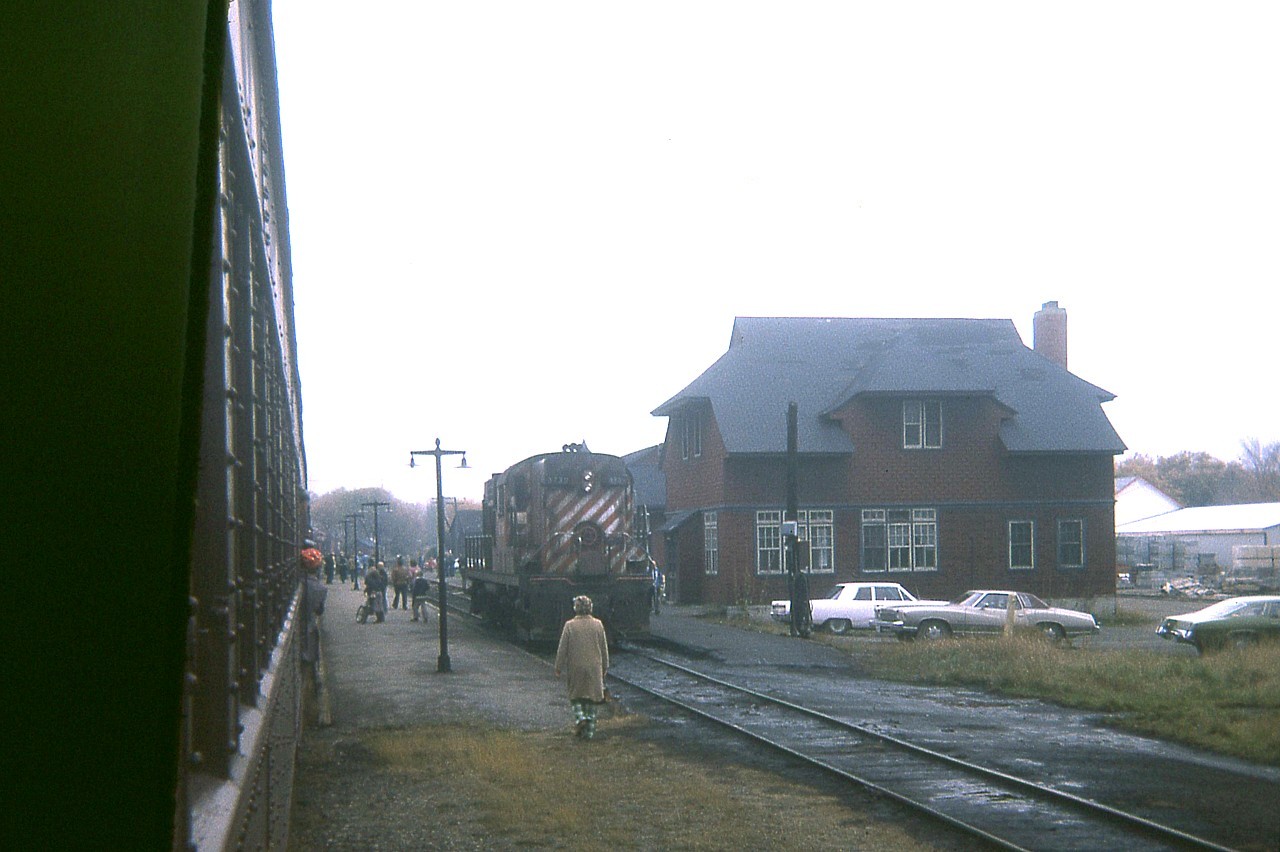 It is a good thing I do not mind crummy day photography. The weather could not have been much worse in the morning of an Ontario Railway Association fantrip to Owen Sound over the weekend of Thanksgiving, 1974. Here we are at Orangeville, in the morning, peering out and rain, mist, and fog. This dreary view shows the resident CP RS-10 awaiting next assignment; the Crew Quarters/restaurant building (destroyed by fire 03/2006) and in behind one can barely make out the old Orangeville station, a beautiful structure which was moved downtown in the 1980s to serve as a restaurant. Note the old lamps along the walkway. Hard to believe, but regular passenger service ended in 1970, only 4 years previous to this image. Save for Trillium moving freight around, all is quiet on the rails here these days.