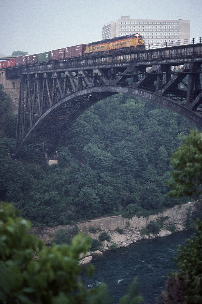 I've posted an image of this train before, a few years ago, but this shot I like because it shows the sheer depth of the Niagara River gorge at this point.  Some have wondered why, since this bridge has been disused for 20 years, it has not been removed. Sure doesn't look like an easy job! Might as well leave it there for another 100 years............
B&O 4291 and 4173 are seen crossing into Canada at the typical time........sundown.......resulting in a difficult shot taken at 45th sec at f2.8.  I was very lucky this photo even turned out. And it was shot exactly 40 years ago.........yesterday.