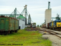 A good overview of what Blenheim was like in 2005. ADM at left, Thompsons at right, the mainline bisecting it all. There was a <a href=http://www.railpictures.ca/?attachment_id=30976 target=_blank> station </a> by the large concrete elevators too at one time. <br><br>The last train I had shot in Blenheim prior to 2/1/2020 was this. I have a habit of turning my attention to things, and just after I get around to it the hammer drops and permanent changes come, this was no different. Not long after I began to capture the CSX in the area we heard the rumours the end was coming and CSX was about to make major changes in Ontario. I only went to Blenheim 3 times under CSX. I wish I could do it again, while I did get some half decent shots, I didn't know what I was doing in 2005. At least you can see the old C&O troop sleeper car and just behind it is the single stall C&O Engine house. The car was donated to the museum in St. Thomas thankfully, but all the C&O/CSX Buildings were razed to the ground shortly after CN took over.<br><br><b>Bonus Audio (2 minutes):</b> <a href=http://steve.hostovsky.com/blenheim_chatham.mp3 target=_blank> RTC recording of the train clearing North Chatham.</a> Under CSX the entire line, including the Rule 105 in Blenheim was under control of the Wallaceburg RTC, you had to ask permission to enter the 105 at Blenheim and call clear of it. They also called clear of south Chatham, plus the OCS clearance itself, so you knew exactly where they were. It was a different time and in 2005, the CSX Sarnia subdivision was a time machine where even I felt it warped me back a couple decades.  Friendly crews and you had the run of the place. Those were the days..