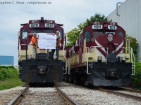 People. The people that make the railway move the people we photograph. While we stop taking photos they are still out there making the cut, walking the train, setting brakes, sometimes in weather that make us complain and go home. They don't go home until the job's done. Ontario Southland Railway had their final day in Guelph today, and while I went into work for a bit, I printed a banner at the last minute and met the trains to convince them to photograph the people who make it all happen whom the OSR crews happily obliged. This is Job 1, who work the mornings and get re-crewed by the 1400 re-crew. To the right is the "RIP" train parked in the siding that Bill Purdy posted earlier. While they waited for their chariot to arrive, they had posed both trains together and I added to their decision by bringing  banner, to the delight of the gaggle of people crowded along Dawson Rd. Pictured right to left is Jamie Rolston, and Jim Frechette, in the hoggers chair is Peter Harwick.  Mr. Rolston ran  the first OSR train on January 2 1998 and helped closed things off today. Thanks guys!<br><br>