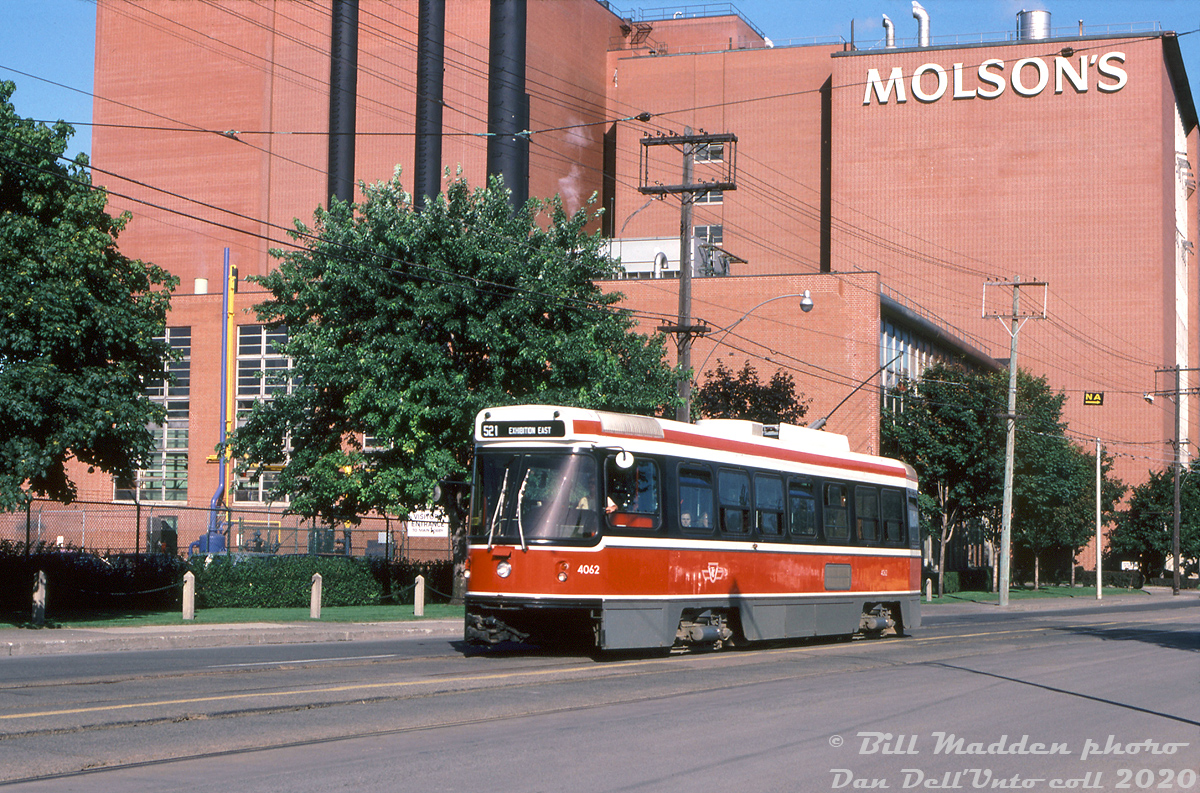 Three-year old TTC CLRV 4062 heads west on Fleet Street west of Bathurst on a Rt.521 Exhibition East run for the CNE's Exhibition Loop, passing by the looming Molson's Brewery plant on Fleet Street. Part of Toronto's at-the-time new fleet of modern CLRV streetcars, 4062 would enjoy a nearly 35 year career until it was retired in 2015 after a collision with a bus. The old streetcar fleet was on the way out for new Bombardier-built cars, so any heavy repairs weren't on the books.

The Molson Fleet Street Brewery was built in 1955 on Toronto's harbourfront and expanded in the 1970's. It was served by rail off CPR's old "Wharf Lead" (ex-TG&B) that ran south from Parkdale through Liberty Village. Information suggests the plant closed in 1989 due to a company reorganization following the merger between Molson and Carling O'Keefe. In the years following, the mothballed plant was used for TV and movie shoots. There were plans to turn it into a telecommunications hub building, but they fell through, and the plant was eventually demolished in 2006 for new condo towers.

William Madden photo, Dan Dell'Unto collection slide.