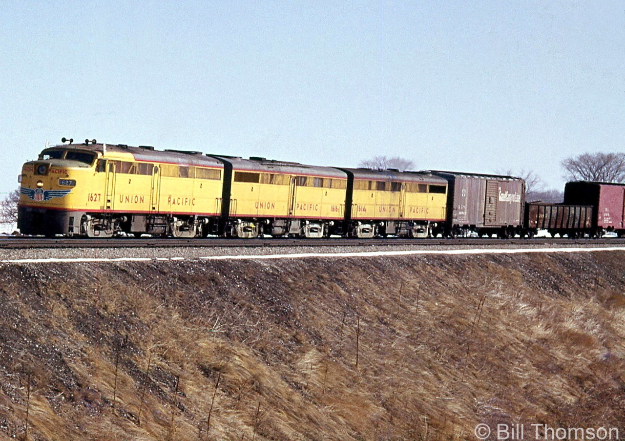 Another photo of a set of Union Pacific Alco FA1/FB1's working on Canadian Pacific, this time units 1627, 1616C and 1614B are shown leading a freight on the Galt Sub, south of Streetsville in 1964. Leased by power-short CP during 1963-1964, the old FA1 and FB1 units UP sent up were run together in sets of 2, 3 or 4 units, typically only running with other UP units during their tenure on CP. The Alco FA/FB's were at the end of their lifespans, and upon return to UP they were used as trade-in units for new power.

More UP Alcos on CP:

Two sets at CP's Lambton Yard: http://www.railpictures.ca/?attachment_id=37872>
Passing the station at Guelph Junction: http://www.railpictures.ca/?attachment_id=16939