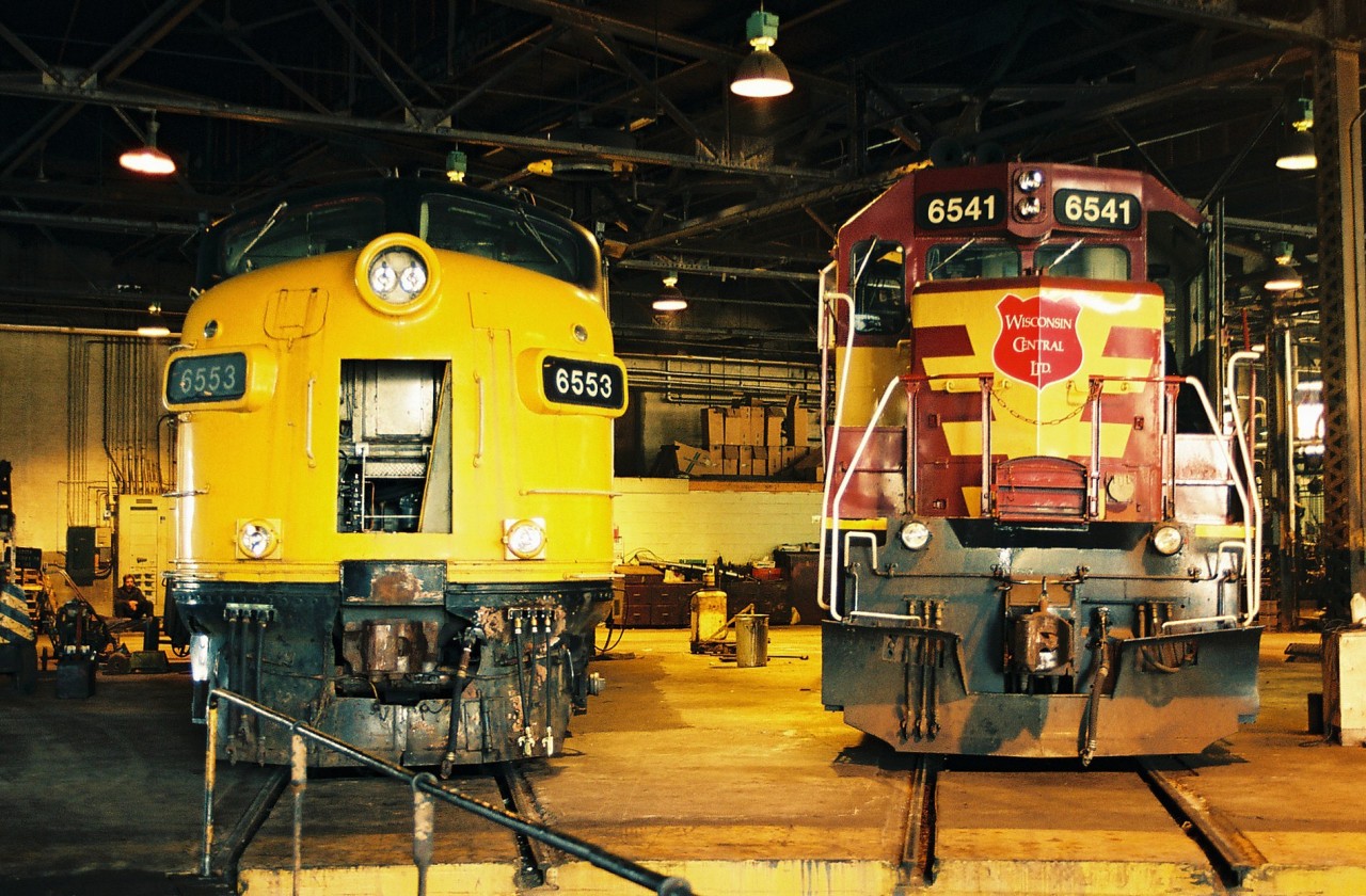 Former VIA Rail FP7A 6553 and Wisconsin Central SD45 6541 share shop space at WC's Sault Ste. Marie diesel facility as both units were in different stages of life. WC 6541 was originally built in 1971 as Burlington Northern, before becoming WC 6541, then re-numbered 7526, before ending its run as NREX 7526. FP7A 6553, which was built for Canadian Pacific in 1953 went on to become Algoma Central FP9A 1756. It was later retired and sold to the West Coast Railway Association in Squamish, British Columbia.