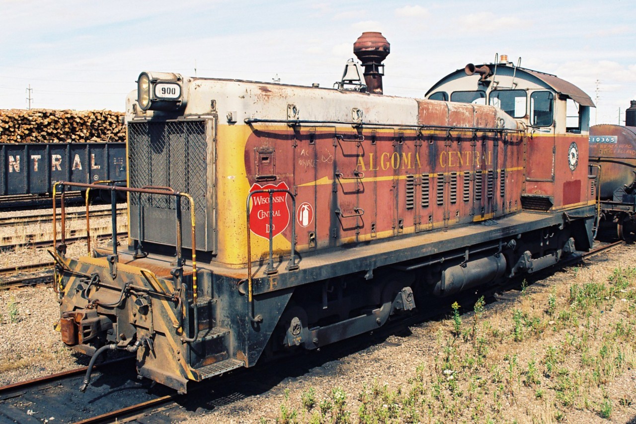Wisconsin Central (WC) SW8 900, which was former Algoma Central Railway (ACR) 140 is seen sitting in WC's  Sault Ste. Marie yard. Earlier that year on January 31, WC had acquired the ACR and all of it's locomotives. The SW8 was built by General Motors in December 1951 and was only ever renumbered by WC as well as given WC logo crests as seen in the photo, never receiving a full repainting. It was eventually sold to Independent Locomotive Service and was given an extended career operating as ILSX 900. 

Rob Smith took this photo a month prior at the same location showing the other side of the unit. HERE