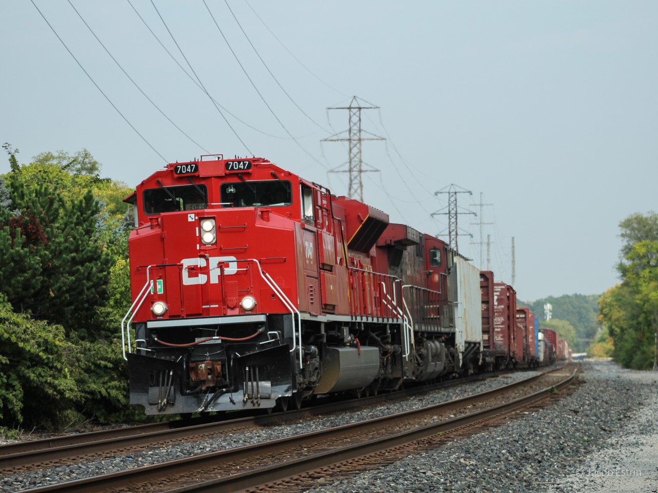 CP 7047 leads 421-24 West on the North Toronto Subdivision with an ACU aswell as an AC44 providing power.