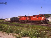 A short CP freight, led by RS18u 1864 and C-424 4237 pulls up to the <a href=http://www.okthepk.ca/dataCprSiding/news/2018/images/2018101006b.jpg>Owen Sound station</a> to drop 2 tanks and 3 Indusmin hoppers in the empty yard.  Little traffic remains on the Owen Sound sub in 1992, and in just over three years the last train will run on October 31, 1995 and the rails lifted to Orangeville shortly after.  The 1947 CPR station survives today as the <a href=http://www.okthepk.ca/dataCprSiding/news/2018/images/2018101006a.jpg>Mudtown Station Restaurant.</a><br><br>CP 1864, built as <a href=http://www.railpictures.ca/?attachment_id=1612>8734</a> at MLW in 1957, would be rebuilt and chopped nosed in 1989 and dealt off to the New Brunswick East Coast Railway in 1998.  2003 would see the unit sent to IRSI shops in Moncton for a rebuild, emerging as Eastern Rail Services demonstrator SFEX 3000, an RS18-3a to be used on the Chemin de Fer de Lanaudière; owned by Quebec's Bell Gaz company.  The unit remains in service as <a href=http://www.railpictures.ca/?attachment_id=27430>CFL 3000.</a>  CP 4237, MLW 1965, would be retired in 1997 and in 1999 was put on <a href=http://www.railpictures.ca/?attachment_id=11678>display at Exporail.</a>