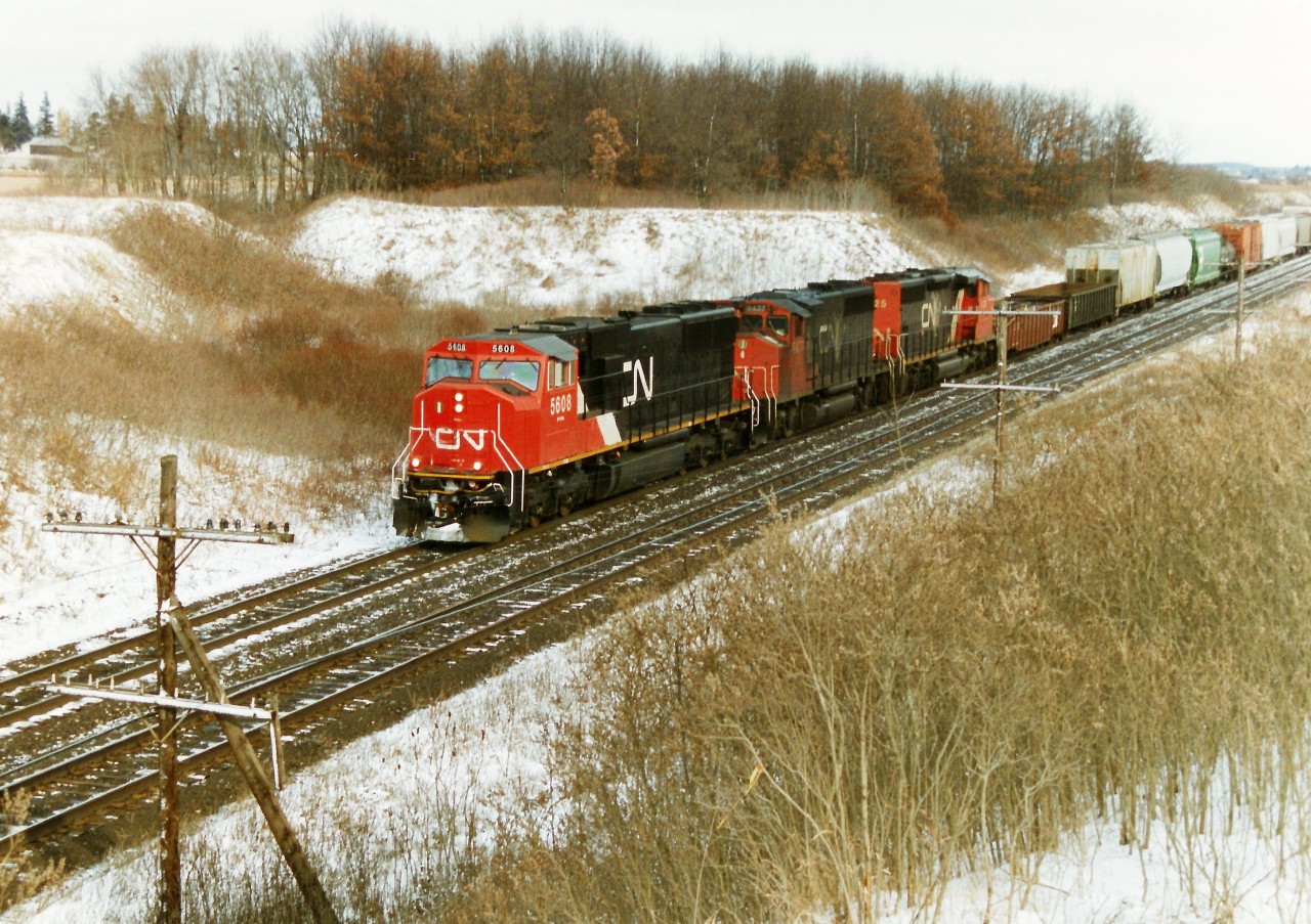 CN 5608 still looks new as it leads train 399 departing Paris West on the Dundas Subdivision with 9477 and 5325 trailing. SD70I 5608 was built and released from the GMDD plant in London a few months prior in 1995 and is enduring it's first winter as it heads west towards the city of it's birthplace during a frigid winter afternoon.