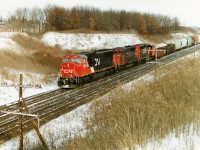 CN 5608 still looks new as it leads train 399 departing Paris West on the Dundas Subdivision with 9477 and 5325 trailing. SD70I 5608 was built and released from the GMDD plant in London a few months prior in 1995 and is enduring it's first winter as it heads west towards the city of it's birthplace during a frigid winter afternoon. 