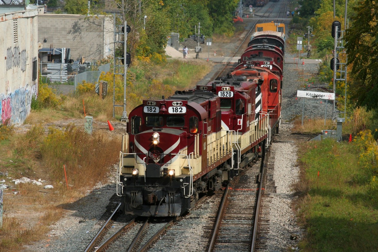 With word that CN X568 would be taking the remaining Ontario Southland Railway (OSRX) equipment from Guelph to London across the CN Guelph Subdivision, I had set aside my lunch hour to photograph the movement near my work in the Baden area. I had several spots in mind and seeing as X568 was restricted to 15mph, due to a non-functioning EOT, a chase would be relatively easy. However, sometimes the best laid plans can fall to pieces in seconds as was the case here, after it was learned that X568 would make it no further west then Kitchener. I believe I left my office chair spinning, as I headed out the door and into my car, then down the highway back east towards Kitchener. Luckily I was able to get there in time thanks to CN 568 doubling over and getting out ahead of X568, which waited patiently on the mainline. 

Here, CN X568 with it's pure Ontario Southland Railway consist is seen crossing over from the mainline to the siding prior to shoving into the Kithchener yard where it would tie-down for the day. This was the first time in almost 20 years I have seen this many railfans in Kitchener and the first time since 1997 that I've photograped an MLW in the city making it a lunch hour to be remembered.