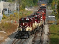With word that CN X568 would be taking the remaining Ontario Southland Railway (OSRX) equipment from Guelph to London across the CN Guelph Subdivision, I had set aside my lunch hour to photograph the movement near my work in the Baden area. I had several spots in mind and seeing as X568 was restricted to 15mph, due to a non-functioning EOT, a chase would be relatively easy. However, sometimes the best laid plans can fall to pieces in seconds as was the case here, after it was learned that X568 would make it no further west then Kitchener. I believe I left my office chair spinning, as I headed out the door and into my car, then down the highway back east towards Kitchener. Luckily I was able to get there in time thanks to CN 568 doubling over and getting out ahead of X568, which waited patiently on the mainline. 
<br>
Here, CN X568 with it's pure Ontario Southland Railway consist is seen crossing over from the mainline to the siding prior to shoving into the Kithchener yard where it would tie-down for the day. This was the first time in almost 20 years I have seen this many railfans in Kitchener and the first time since 1997 that I've photograped an MLW in the city making it a lunch hour to be remembered. 




