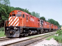 A matching set of Montreal Locomotive Works-built C424's (CP 4216 leading 4207, 4204, 4209 and 4222) sit tied-down on the head end of their train at the south end of Kinnear Yard, nearly ready to depart down the Hamilton Sub with an acid train. Originally built in the mid 60's as road freight units and later rebuilt in the early 1980's for roadswitcher work, power-short CP kept their fleet of 4-axle C424 "Centuries" in service well into the 90's until the last few retired in 1998. I'm not sure if Bill and Reg Button were chasing this train together, but Reg managed to shoot it further down the line at both <a href=http://www.railpictures.ca/?attachment_id=38098><b>Brookfield</b></a> and <a href=http://www.railpictures.ca/?attachment_id=38939><b>outside of Niagara Falls</b></a>. <br><br> <i>Bill McArthur photo, Dan Dell'Unto collection slide</i>