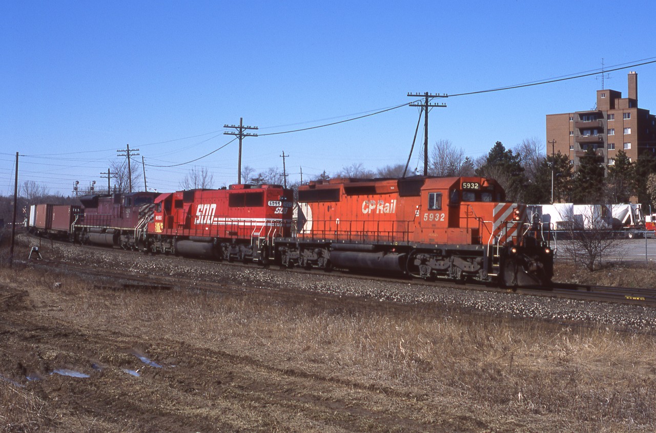 CP5932, SOO6055, and CEFX121 lead an eastbound 138 through Streetsville Ontario on clear March day.