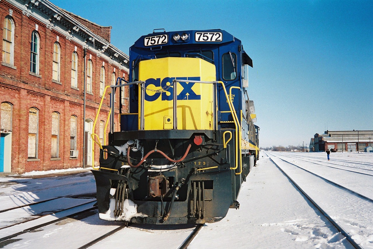 By early 1994, the Railway Capital of Canada was a far cry from its former glory days, however compared to today St. Thomas was still actually an active city as far as being served by different railroads. Long gone were the days of Conrail, Chessie and any passenger trains, however CSX, NS, CN and CP trains still converged on the city. CSX was still operating across the CASO Subdivision, however not for much longer, while NS still ran dedicated auto parts trains on the Cayuga and Paynes Subdivisions, although that window was shortly closing too. In nearby Talbotville, CN served the huge Ford assembly plant and had a large yard with several assignments based, including serving industries on the Cayuga Subdivision. Also, CP came into the city regularly on their St. Thomas Subdivision. 

Here on an incredibly cold but sunny winter afternoon, CSX 7572 and 7756 are viewed idling beside the historic Canada Southern Railway station. This power was likely off CSX R320, which would tie-down here and not continue to Buffalo. Eventually it would become R321 simply departing St Thomas then it would ‘cab hop’ to Fargo, where it would lift all the traffic off the North end and continue to Windsor and Detroit.