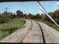 A quick photo out the front window as we head north into the curve that leads to the diamond with the CPR. I cannot remember any particulars about this speeder except that it was yellow, which makes me think it may have been ex-CPR. It was certainly a rough ride, the only rail equipment I recall that had a bumpier ride were the trackmobiles we used at the ESSO Chemical (Beamer) plant.