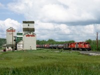 Eastbound wayfreight out of Red Deer on a Halkirk turn passes a feedmill at Clive